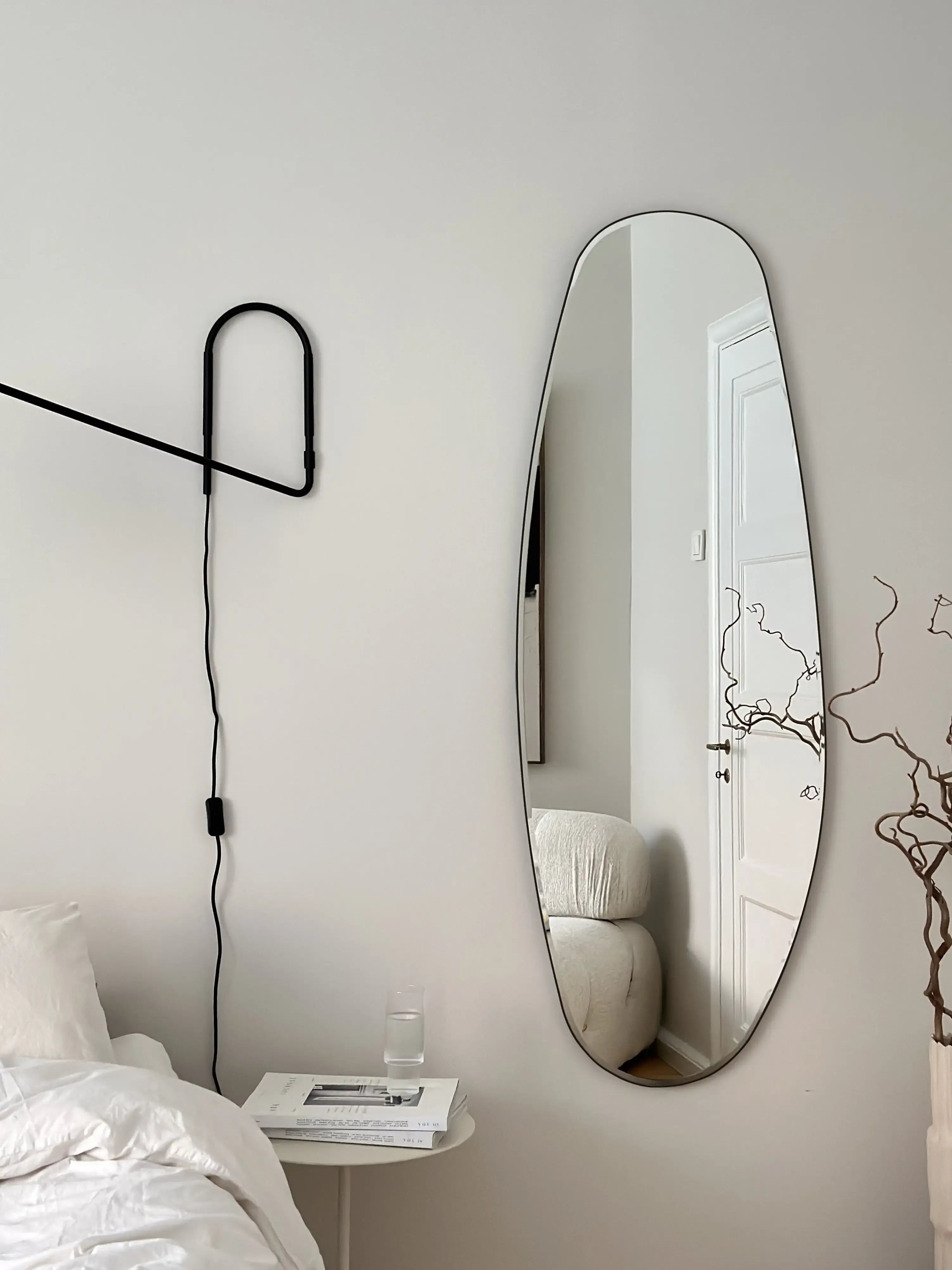 Opal Mirror Large mounted vertically in a serene, modern bedroom.