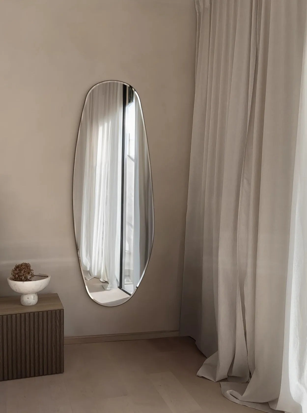 Opal Mirror Large in room next to curtains