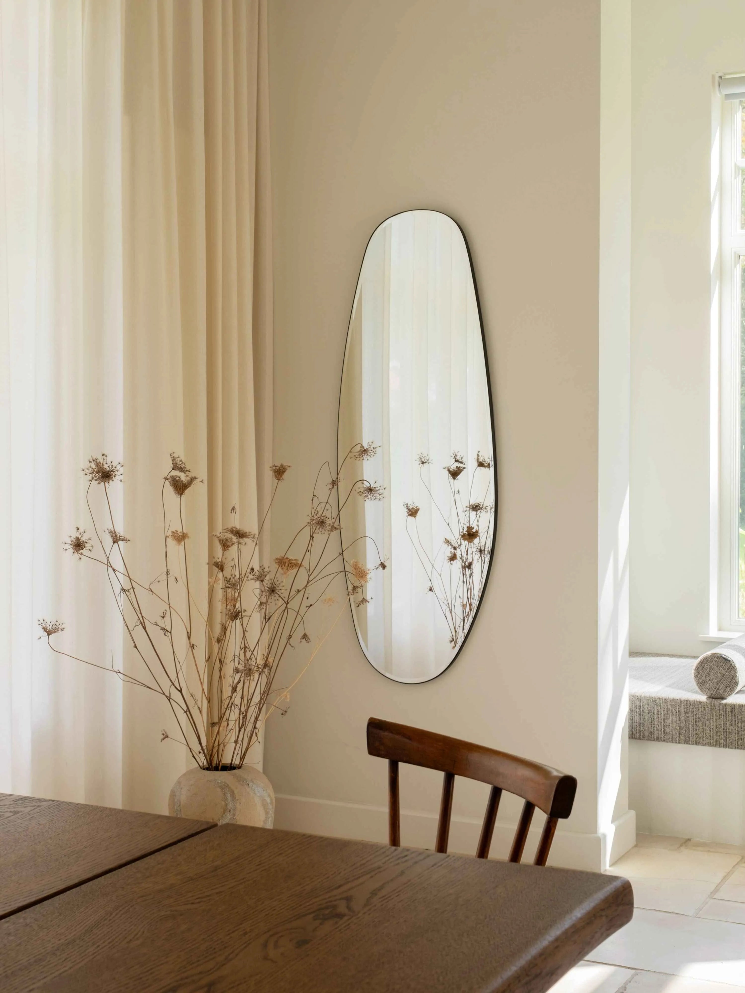 Opal Mirror Large in beautiful dining area reflecting dried flowers
